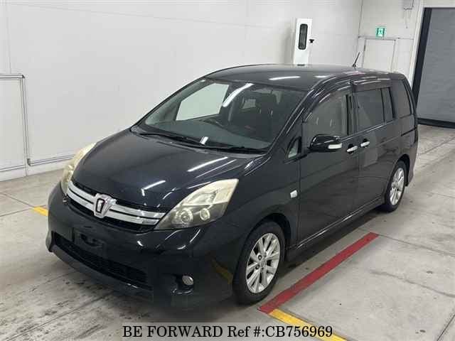 A grey JDM sports car speeding down a highway at night.