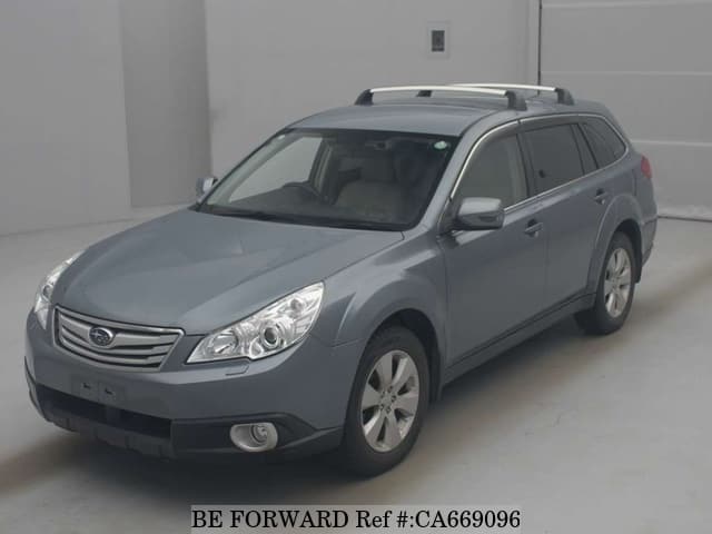 A grey JDM sports car speeding down a highway at night.