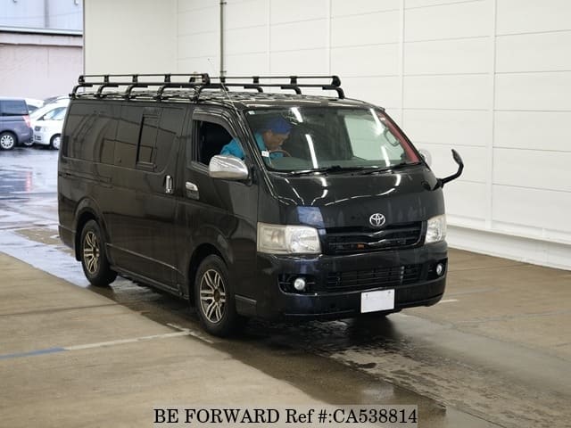 A grey JDM sports car speeding down a highway at night.