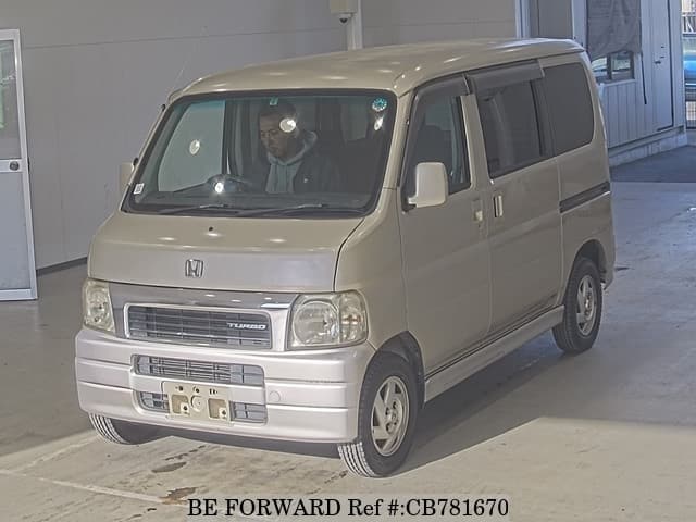 A grey JDM sports car speeding down a highway at night.