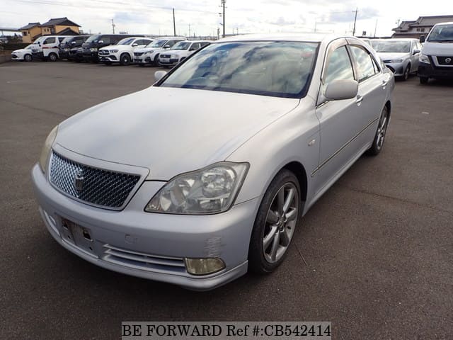 A grey JDM sports car speeding down a highway at night.