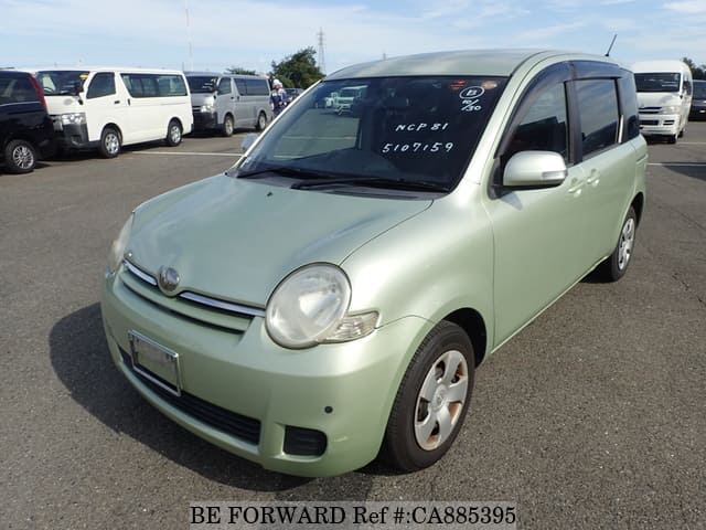 A grey JDM sports car speeding down a highway at night.