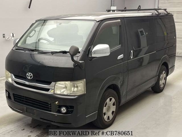 A grey JDM sports car speeding down a highway at night.