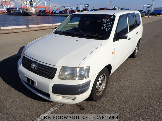 A grey JDM sports car speeding down a highway at night.