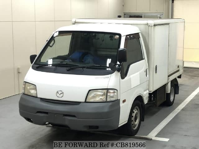 A grey JDM sports car speeding down a highway at night.