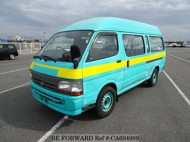 A grey JDM sports car speeding down a highway at night.
