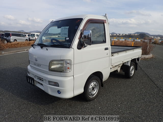 A grey JDM sports car speeding down a highway at night.