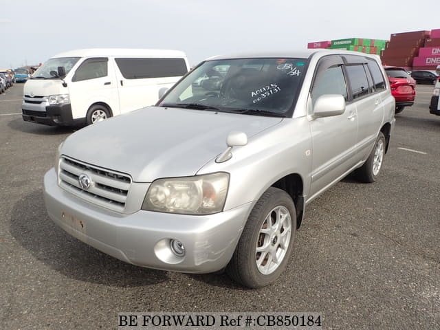 A grey JDM sports car speeding down a highway at night.