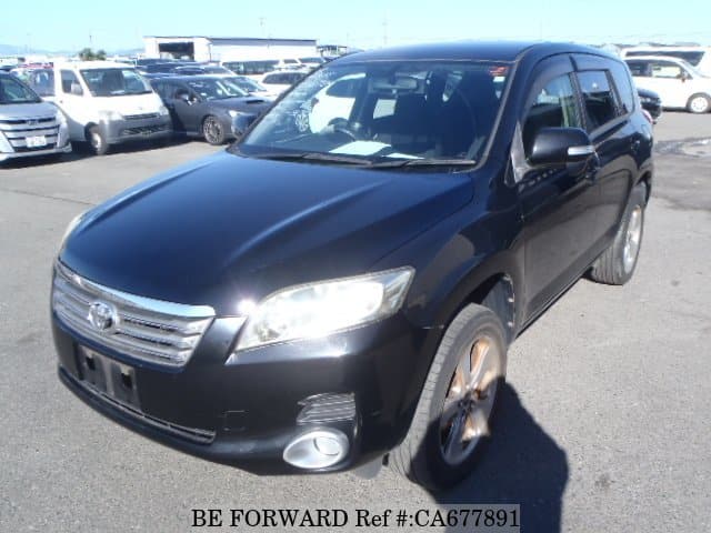 A grey JDM sports car speeding down a highway at night.
