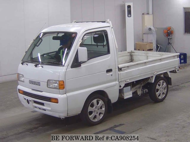 A grey JDM sports car speeding down a highway at night.