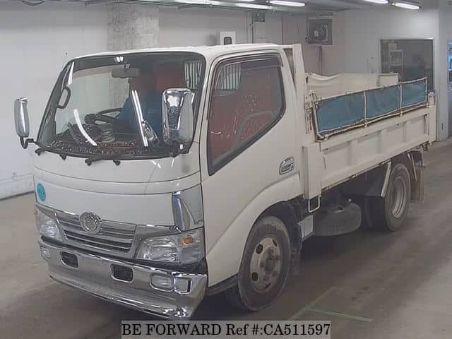 A grey JDM sports car speeding down a highway at night.
