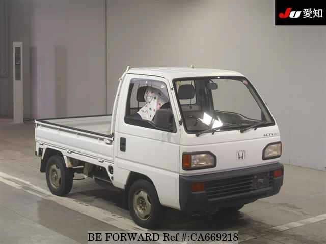 A grey JDM sports car speeding down a highway at night.