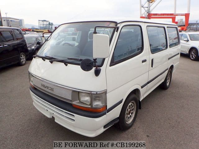 A grey JDM sports car speeding down a highway at night.