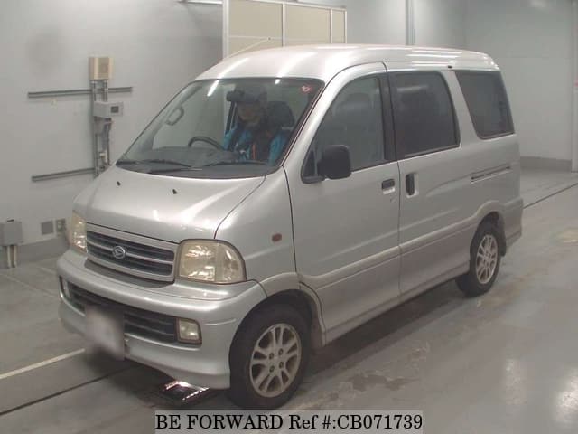 A grey JDM sports car speeding down a highway at night.