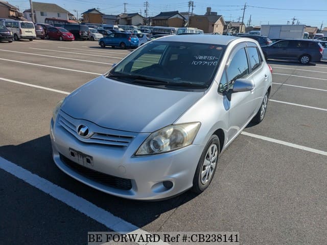 A grey JDM sports car speeding down a highway at night.