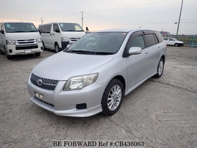 A grey JDM sports car speeding down a highway at night.