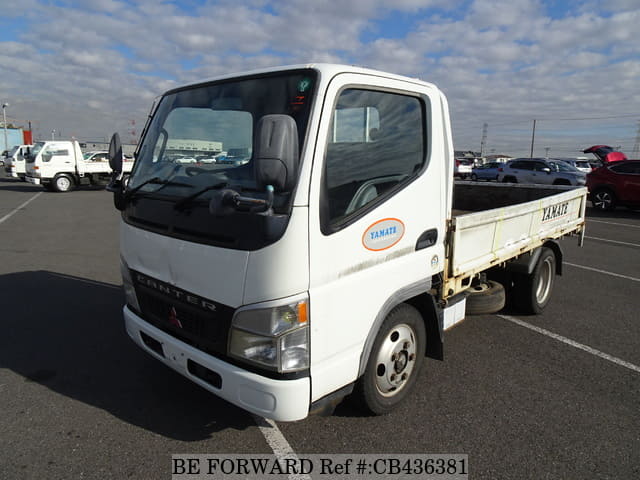 A grey JDM sports car speeding down a highway at night.