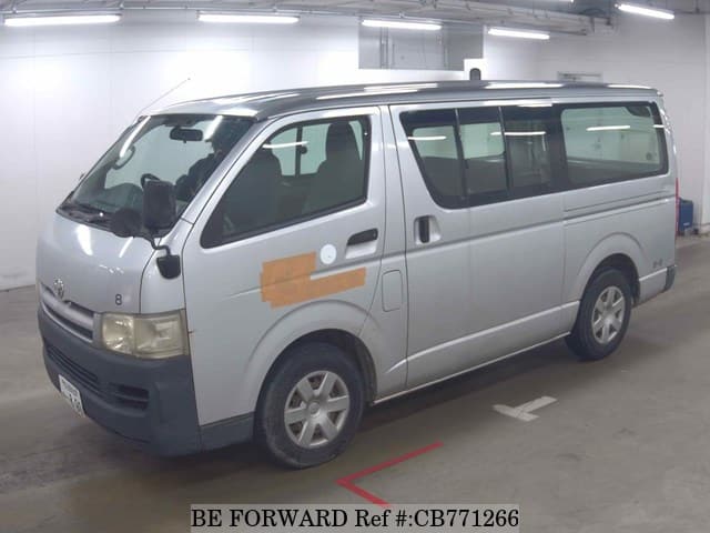 A grey JDM sports car speeding down a highway at night.