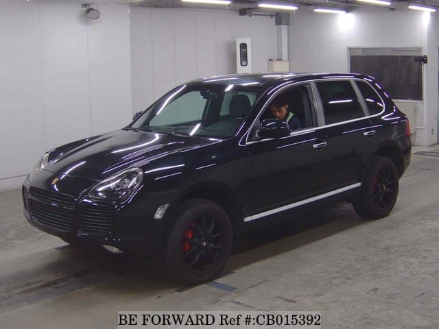 A grey JDM sports car speeding down a highway at night.