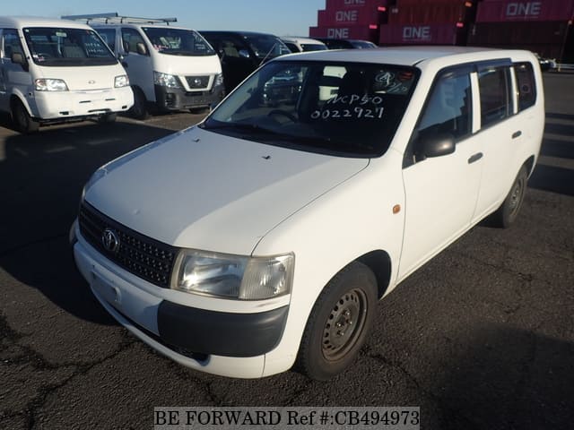 A grey JDM sports car speeding down a highway at night.