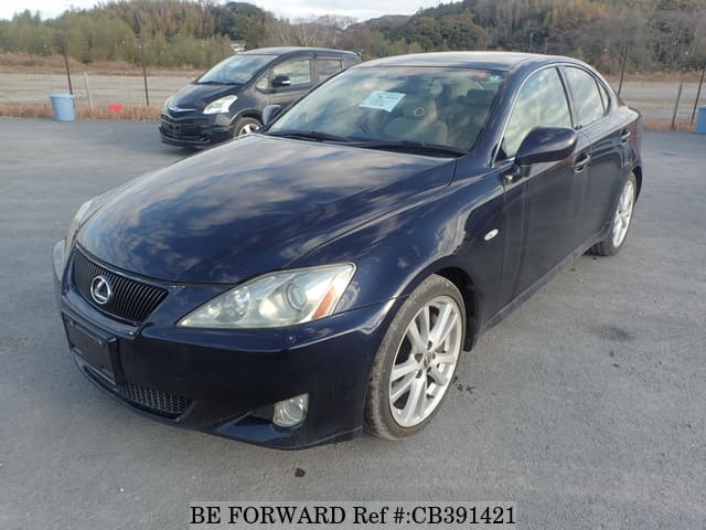 A grey JDM sports car speeding down a highway at night.