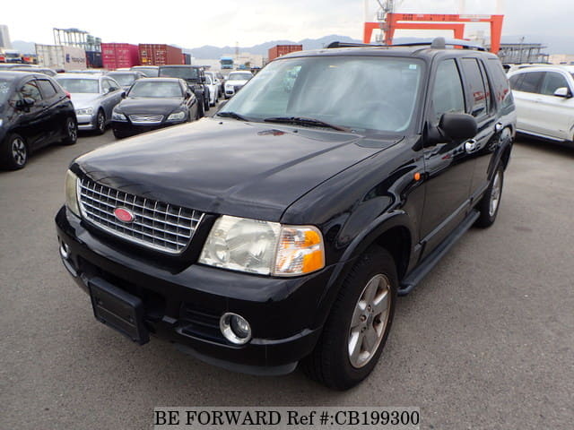 A grey JDM sports car speeding down a highway at night.
