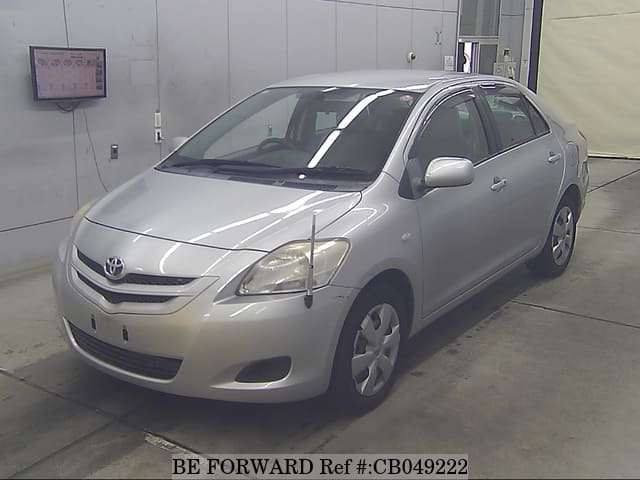 A grey JDM sports car speeding down a highway at night.