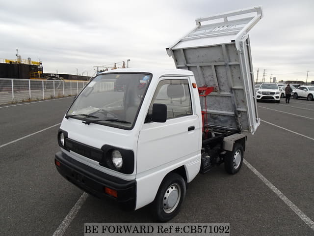 A grey JDM sports car speeding down a highway at night.