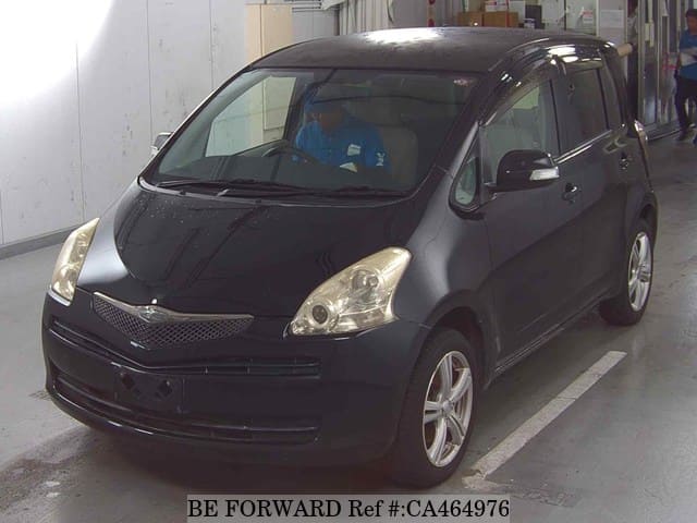 A grey JDM sports car speeding down a highway at night.