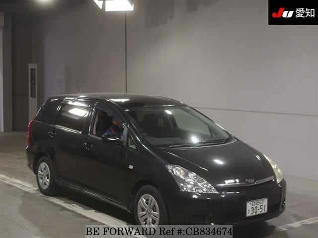 A grey JDM sports car speeding down a highway at night.