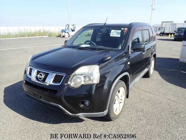 A grey JDM sports car speeding down a highway at night.