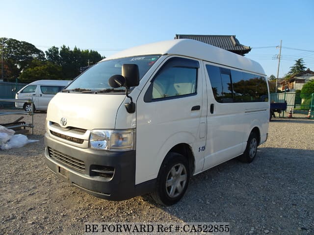 A grey JDM sports car speeding down a highway at night.
