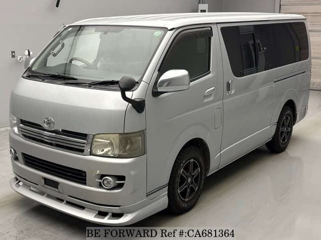 A grey JDM sports car speeding down a highway at night.