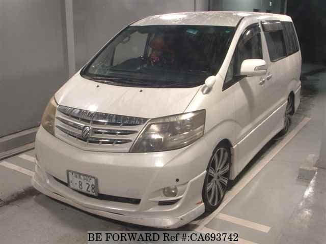 A grey JDM sports car speeding down a highway at night.