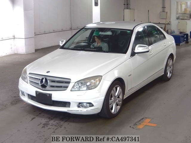 A grey JDM sports car speeding down a highway at night.