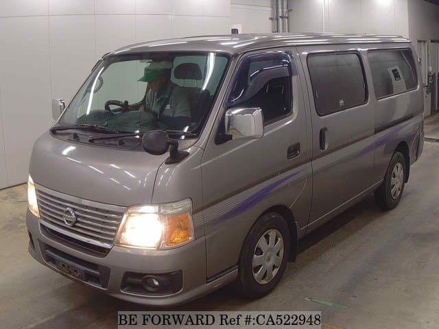 A grey JDM sports car speeding down a highway at night.
