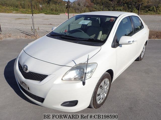 A grey JDM sports car speeding down a highway at night.