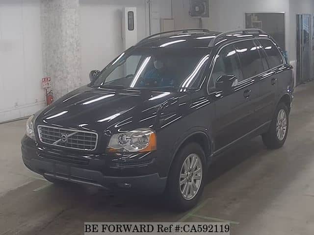 A grey JDM sports car speeding down a highway at night.