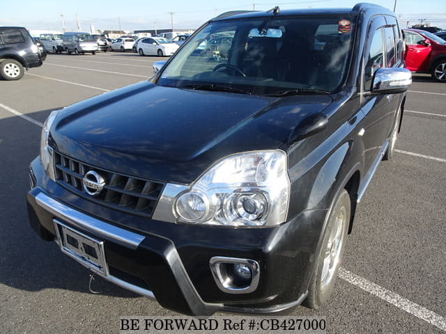 A grey JDM sports car speeding down a highway at night.