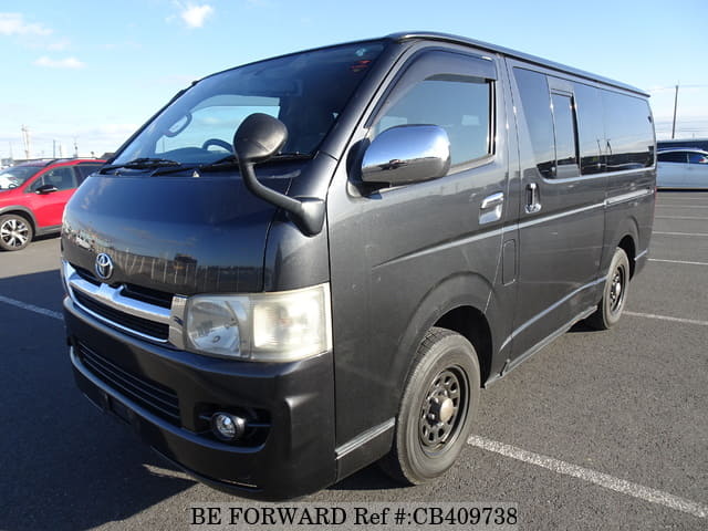 A grey JDM sports car speeding down a highway at night.