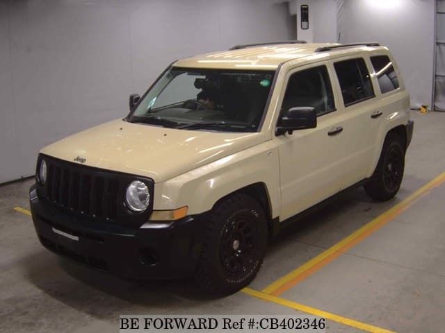 A grey JDM sports car speeding down a highway at night.
