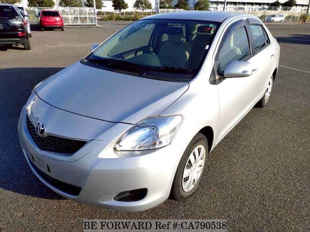 A grey JDM sports car speeding down a highway at night.