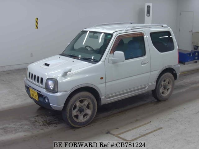 A grey JDM sports car speeding down a highway at night.
