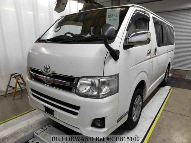 A grey JDM sports car speeding down a highway at night.