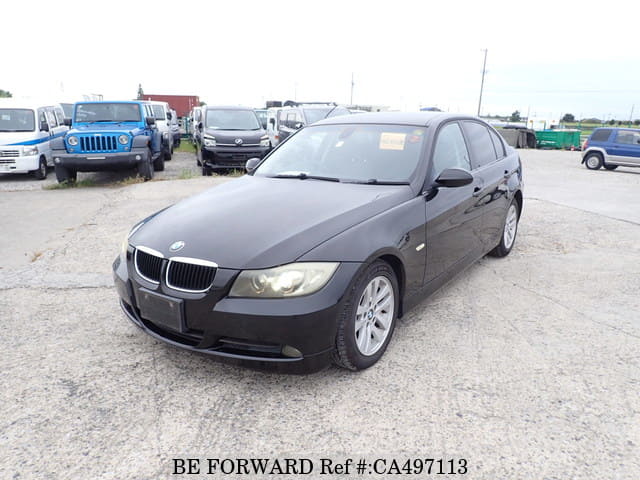 A grey JDM sports car speeding down a highway at night.