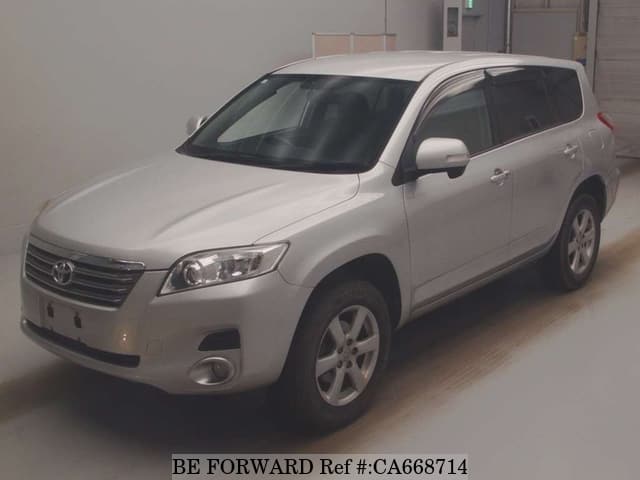 A grey JDM sports car speeding down a highway at night.