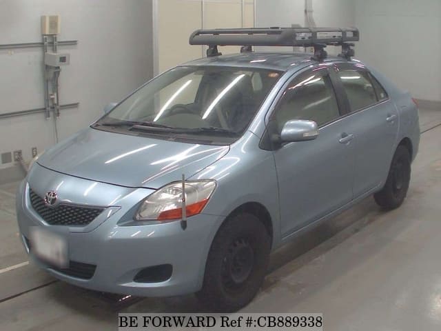 A grey JDM sports car speeding down a highway at night.