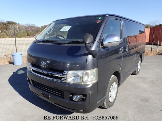 A grey JDM sports car speeding down a highway at night.