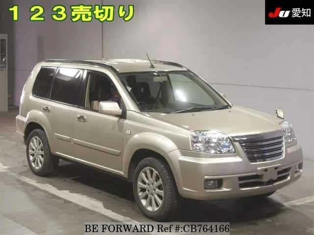 A grey JDM sports car speeding down a highway at night.