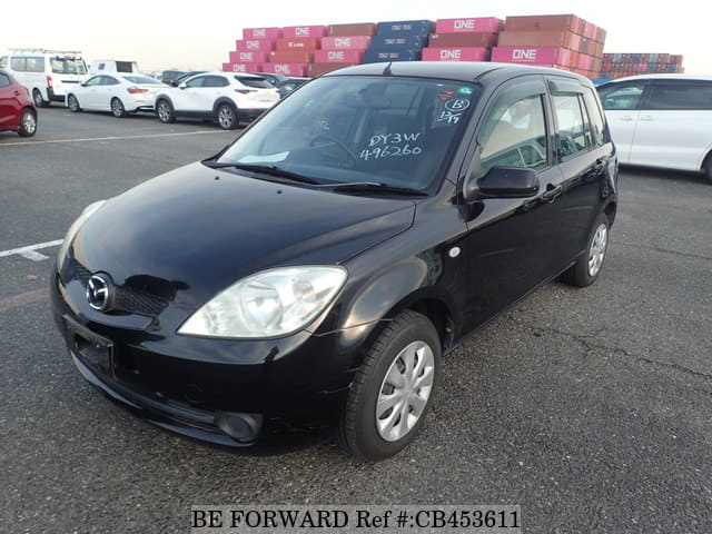 A grey JDM sports car speeding down a highway at night.